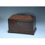 A GEORGIAN MAHOGANY TEA CADDY, of rectangular architectural form, the hinged lid opening to reveal