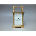 A BRASS CASED CARRIAGE CLOCK RETAILED BY 'COTTRILLS', the enamel dial with Roman numerals, the