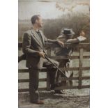 A MID 20TH CENTURY VINTAGE ADVERTISING SIGN DEPICTING TWO GENTS IN COUNTRY ATTIRE STOOD BY A GATE,