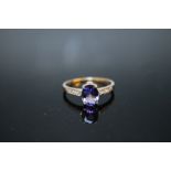 A HALLMARKED 14K WHITE GOLD OVAL AAA TANZANITE AND TANZANITE RING, coming with certificate stating