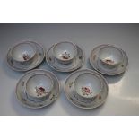 A SET OF FIVE ORIENTAL TEA BOWLS WITH STANDS, decorated with floral detail