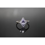 A HALLMARKED 9 CARAT WHITE GOLD TANZANITE RING, set with thirteen tanzanites in a diamond shape,