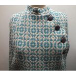 A VINTAGE WELSH WOOL TAPESTRY CAPE, fully lined, having matching belt, four offset buttons and press