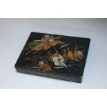 A JAPANESE PAPIER MACHE LIDDED BOX, the hinged lid with painted decoration depicting fighting