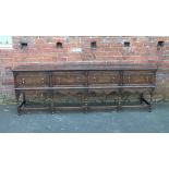 AN OAK REPRODUCTION FOUR DRAWER DRESSER IN THE JACOBEAN STYLE, crossbanded detail to the drawers,