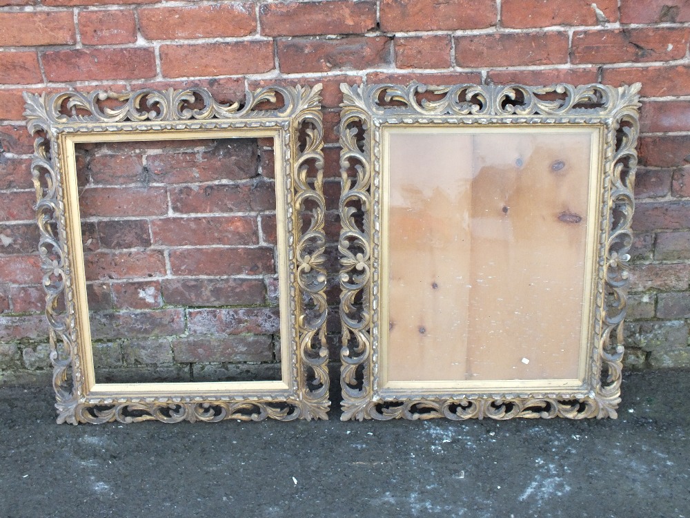 A PAIR OF GILT WOOD FLORENTINE STYLE PICTURE FRAMES, typical scrolling Florentine detail, rebate