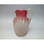 A VICTORIAN CRANBERRY CRACKLE GLASS JUG, the body of twisted form, having applied clear glass rope