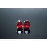 A PAIR OF 10K YELLOW GOLD RUBY EARRINGS, each oval stone measuring approx 11 mm by 8 mm