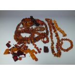 A COLLECTION OF VINTAGE AND MODERN AMBER AND LUCITE COSTUME JEWELLERY, comprising three necklaces,
