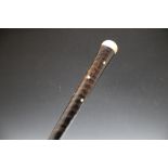 A 19TH CENTURY COLONIAL ORYX HORN WALKING CANE, domed pommel with inset mother of pearl to centre,