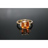 A HALLMARKED 9K GOLD PADPARADSCHA QUARTZ AND DIAMOND RING, coming with certificate stating the
