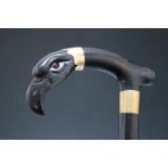A VICTORIAN EBONISED WALKING STICK WITH CARVED HORN HANDLE IN THE FORM OF AN EAGLES HEAD, with inset