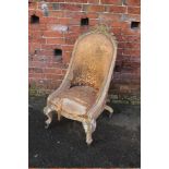 A 19TH CENTURY GILTWOOD CARVED UPHOLSTERED CHAIR, the silk floral upholstery in need of renovation