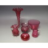 A COLLECTION OF VINTAGE CRANBERRY GLASS, mostly Victorian examples, to include three jugs of varying