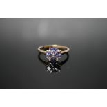 A HALLMARKED 9 CARAT GOLD TANZANITE RING, in a four leaf clover type setting, approx weight 2.2g,