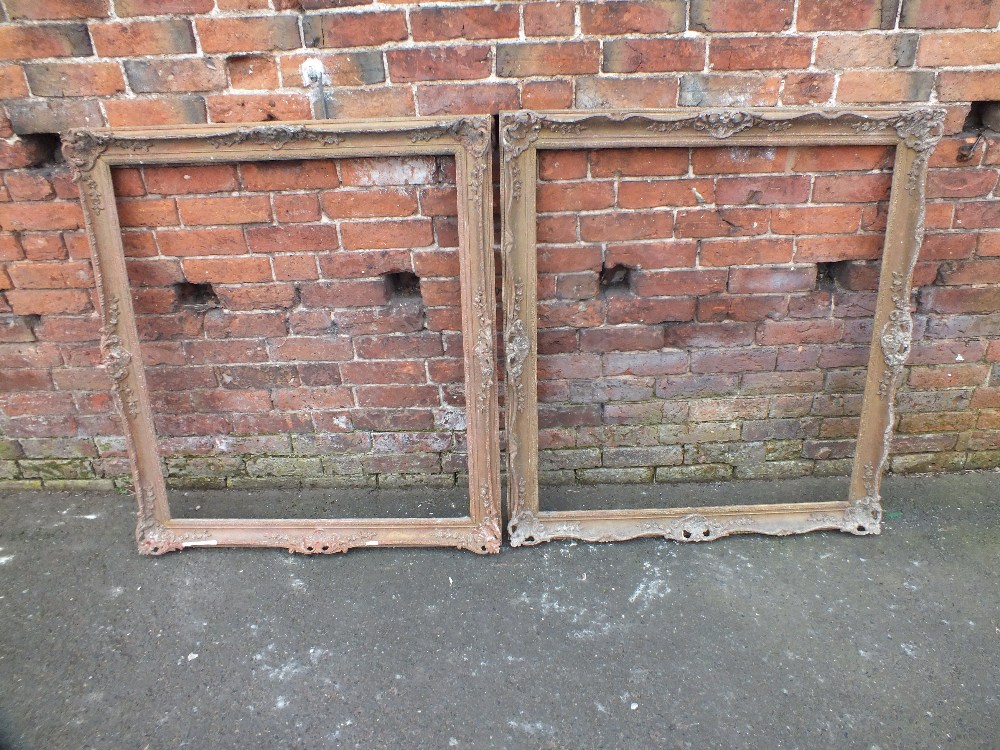 A NEAR PAIR OF ANTIQUE GILTWOOD PICTURE FRAMES, each with foliate moulded decoration and pierced