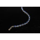 A HALLMARKED 9 CARAT GOLD SUNDAR KYANITE BRACELET, coming with a certificate that states the