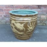 A LARGE ORIENTAL STONEWARE JARDINIERE, the exterior brown glaze with typical dragon decoration and