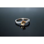 A HALLMARKED 9 CARAT GOLD OURO PRETO YELLOW IMPERIAL TOPAZ RING, set with white stones to the