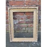 AN ANTIQUE CARVED GILTWOOD PICTURE FRAME, with moulded fruit decoration, rebate 42 x 32 cm