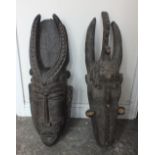 TWO LARGE CARVED WOODEN TRIBAL MASKS - OF POSSIBLE IVORY COAST ORIGIN, of typical form, both