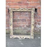 AN ANTIQUE CARVED GILTWOOD PICTURE FRAME, with acanthus moulded detail and pierced decoration,