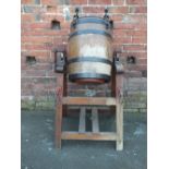 AN ANTIQUE COOPERED END OVER END BUTTER CHURN ON STAND, the metal brackets marked 'Waide & Sons',