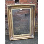 AN ANTIQUE GILTWOOD PICTURE FRAME, moulded detail to each corner, glazed, rebate 49 x 73 cm