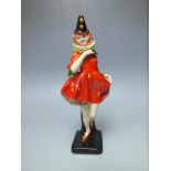 A ROYAL DOULTON 'PIERRETTE' FIGURE - MODEL HN1391, modelled as a female clown holding a mask,