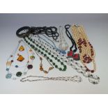 A COLLECTION OF VINTAGE GLASS AND BEAD NECKLACES, to include an opera length hand -knotted jet /