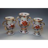 A VICTORIAN IRONSTONE VASE GARNITURE, each with twin handles and Bacchus masks, floral decoration,