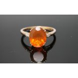 A HALLMARKED 9 CARAT YELLOW GOLD FIRE OPAL RING, with a large oval claw set fire opal measuring