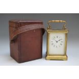A VICTORIAN BRASS CASED CARRIAGE CLOCK IN CARRY CASE, enamel face with Roman numerals, the brass
