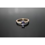 A HALLMARKED 9 CARAT GOLD TANZANITE RING, with a rectangular style claw set tanzanite, approx weight