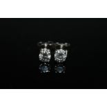 A PAIR OF BRILLIANT CUT DIAMOND STUD EARRINGS, claw set in 18 carat white gold and totaling approx