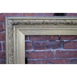 A 19TH CENTURY GILTWOOD PICTURE FRAME, with foliate moulded detail, rebate 79 x 97 cm