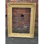 AN ANTIQUE GILTWOOD CARVED PICTURE FRAME, with foliate moulded detail, rebate 60 x 85 cm