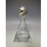 AN 'OTTAVIANI' HEAVY CRYSTAL DECANTER WITH SILVER LION HEAD STOPPER, the pyramid shaped glass body