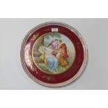 A CONTINENTAL VIENNA TYPE PORCELAIN CHARGER DECORATED IN CLASSICAL STYLE