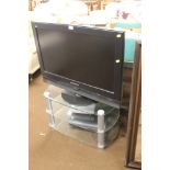 A DAEWOO FLATSCREEN TV ON STAND TOGETHER WITH A DVD PLAYER, ETC