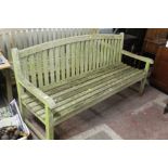 A LARGE WOODEN GARDEN BENCH