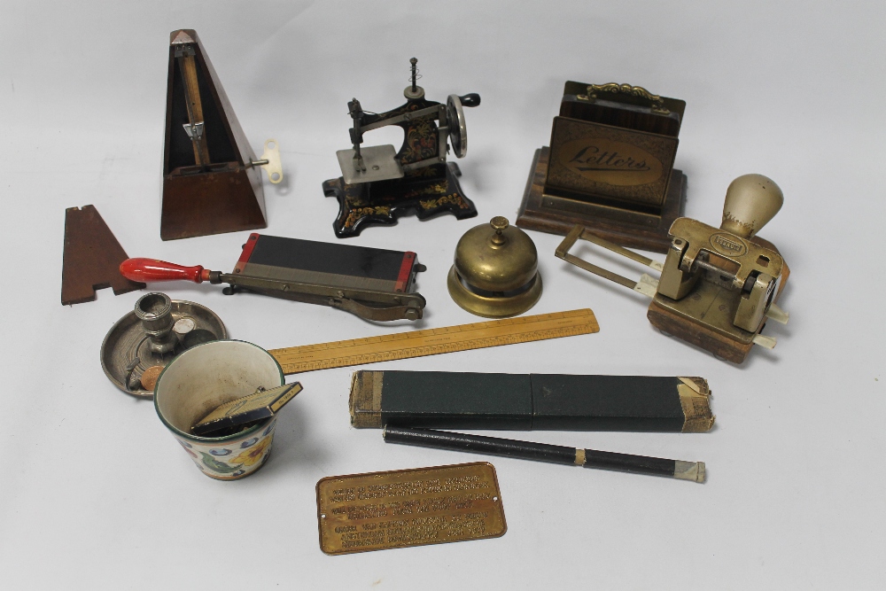 A TRAY OF COLLECTABLES to include a toy sewing machine, desk top items, a table bell etc.