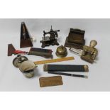 A TRAY OF COLLECTABLES to include a toy sewing machine, desk top items, a table bell etc.