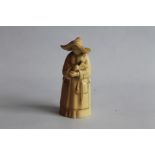 A ROYAL WORCESTER CANDLE SNUFFER, in the form of a nun, in blush ivory. H.9.5 cm