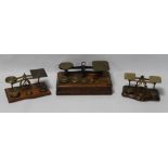 THREE SETS OF BRASS AND WOOD POSTAL SCALES, together with a quantity of assorted weights