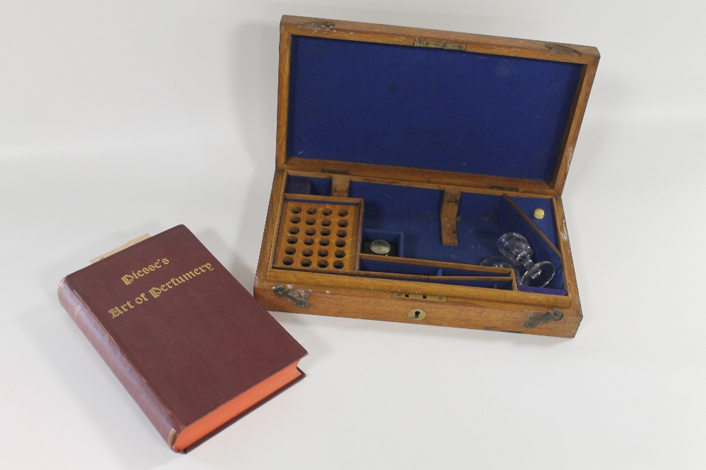 A PERFUMER'S WOODEN BOX WITH PART CONTENTS and a copy of 'Piesse's Art of Perfumery', 5th Edition 1