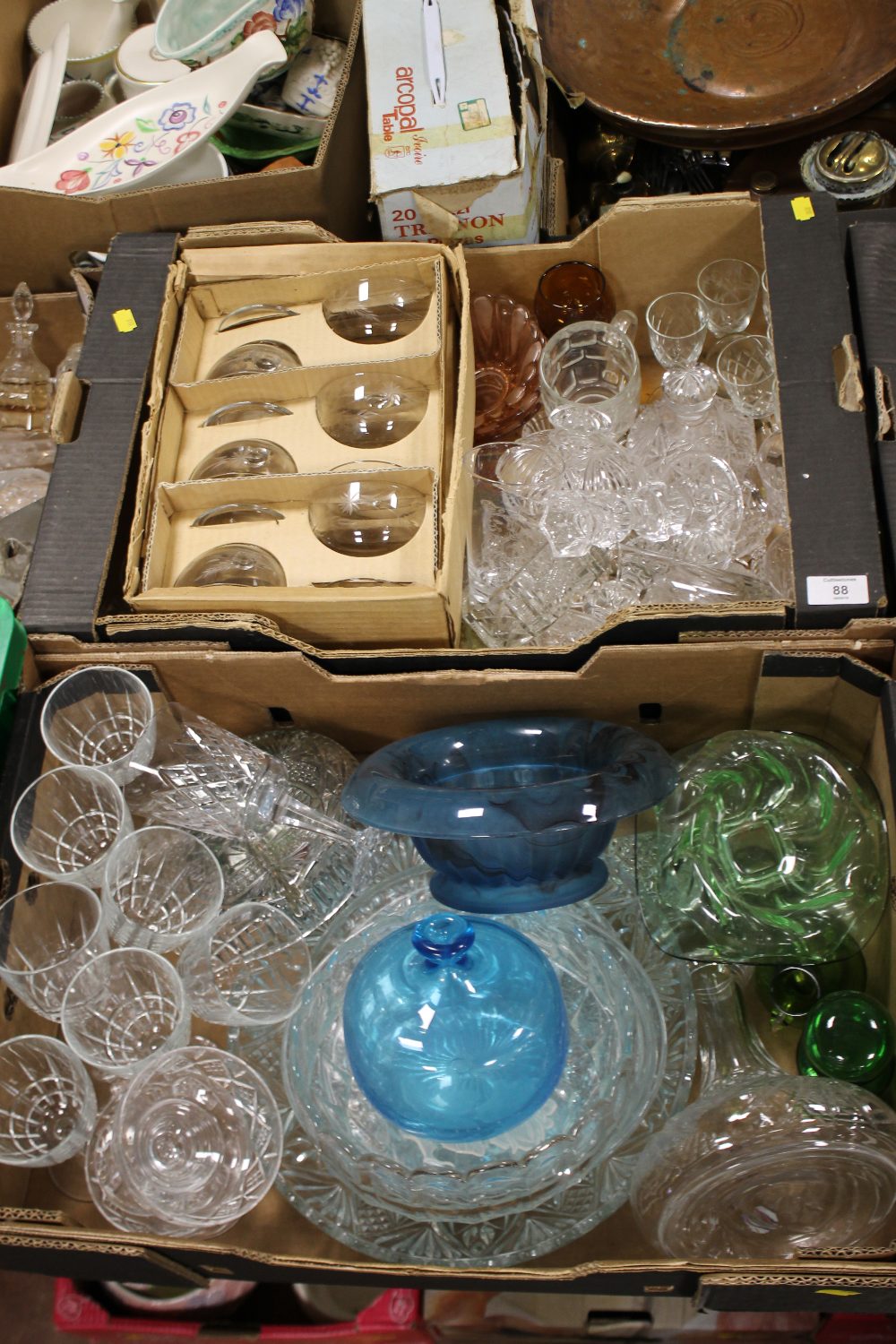 TWO TRAYS OF CUT AND COLOURED GLASSWARE TO INCLUDE A SIGNED BLUE GLASS VASE, DRINKING GLASSES ETC.