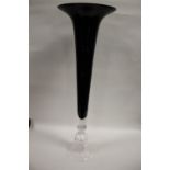 A TALL BLACK AND CLEAR GLASS TRUMPET VASE