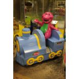 A CHILDS 'BARNEY' RIDE-ON COIN ACTIVATED TRAIN