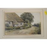 A WATERCOLOUR OF A COUNTRY COTTAGE WITH LABEL VERSO RE JOSEPH FINNEMORE 1860-1939 AND OLD BONHAMS